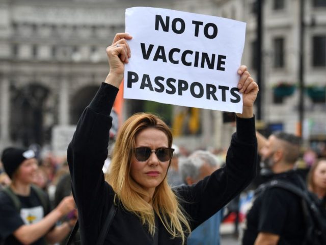 A protestor displays an anti-vax placard during a 'Unite For Freedom' march agai