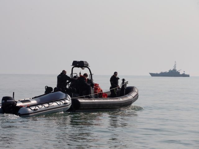 DEAL, ENGLAND - SEPTEMBER 14: Border Force Officials recover a dinghy after migrants lande