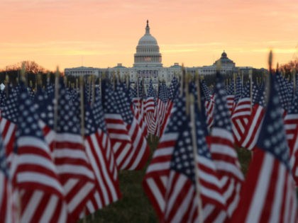 WASHINGTON, DC - JANUARY 18: The U.S Capitol Building is prepared for the inaugural ceremonies for President-elect Joe Biden as American flags are placed in the ground on the National Mall on January 18, 2021 in Washington, DC. The approximately 191,500 U.S. flags will cover part of the National Mall …