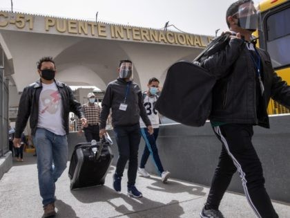CIUDAD JUAREZ, MEXICO - MARCH 16: Asylum seekers leave Mexico while walking into the United States on March 16, 2021 in Ciudad Juarez, Mexico. Some 50 asylum seekers were officially allowed to cross the Santa Fe International Bridge as part of the Biden administration's unwinding of the Trump-era Migrant Protection …
