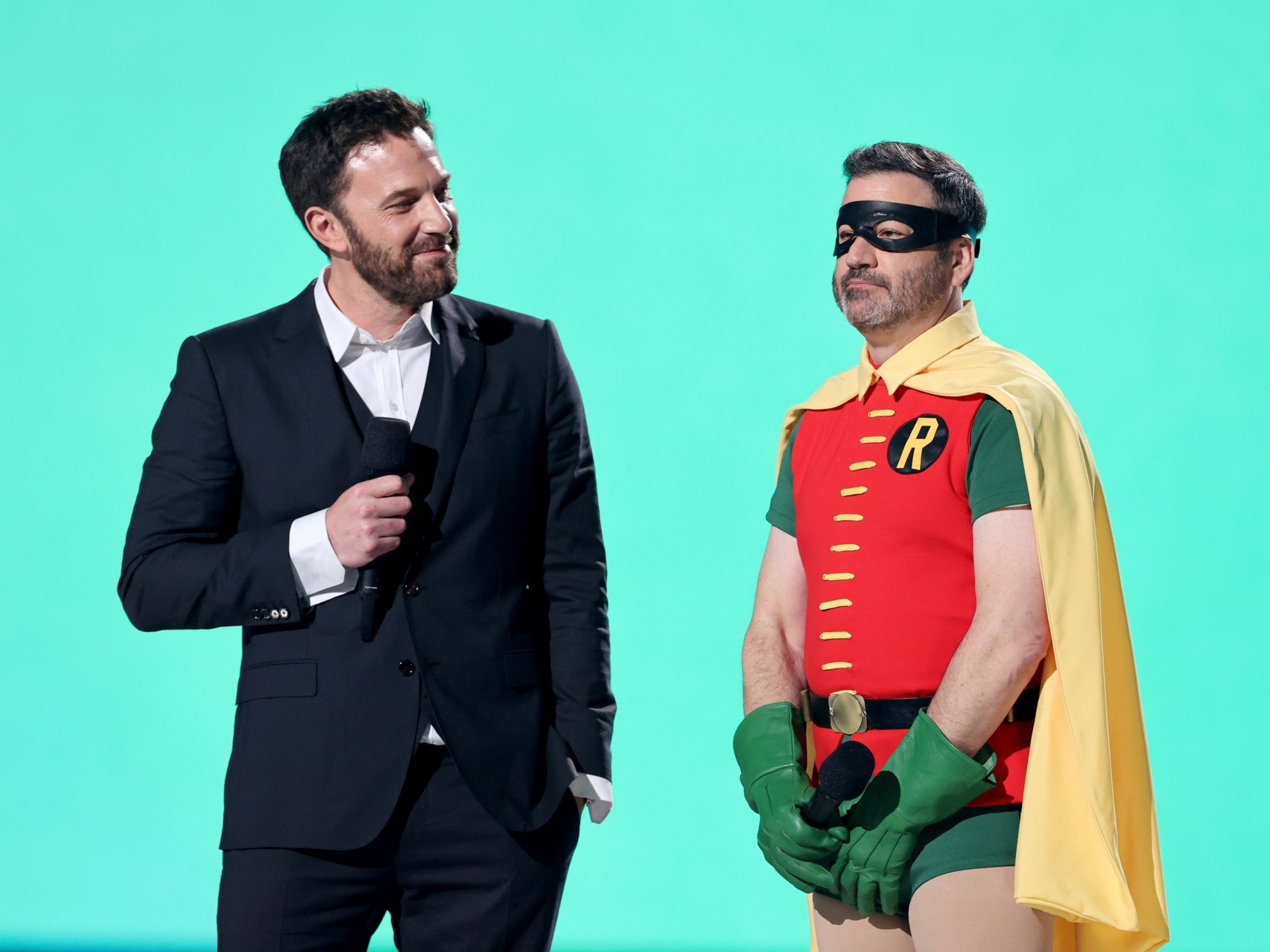 INGLEWOOD, CALIFORNIA: In this image released on May 2, (L-R) Ben Affleck and Jimmy Kimmel (in costume as Robin) speak onstage during Global Citizen VAX LIVE: The Concert To Reunite The World at SoFi Stadium in Inglewood, California. Global Citizen VAX LIVE: The Concert To Reunite The World will be broadcast on May 8, 2021. (Photo by Kevin Winter/Getty Images for Global Citizen VAX LIVE)