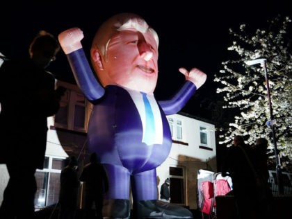 HARTLEPOOL, ENGLAND - MAY 07: People walk past a giant inflatable representation of Prime Minister Boris Johnson outside the Mill House Leisure Centre where the count process for the Hartlepool Parliamentary By-election is taking place on May 07, 2021 in Hartlepool, England. Hartlepool will decide between returning a Labour Party …