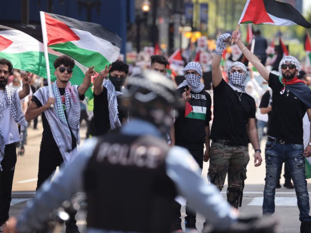 CHICAGO, ILLINOIS - MAY 16: People march through downtown protesting Israeli airstrikes in the Gaza Strip on May 16, 2021 in Chicago, Illinois. The death toll in Gaza continues to rise as the region is seeing the worst outbreak of violence since the 2014 Gaza war. (Photo by Scott Olson/Getty …