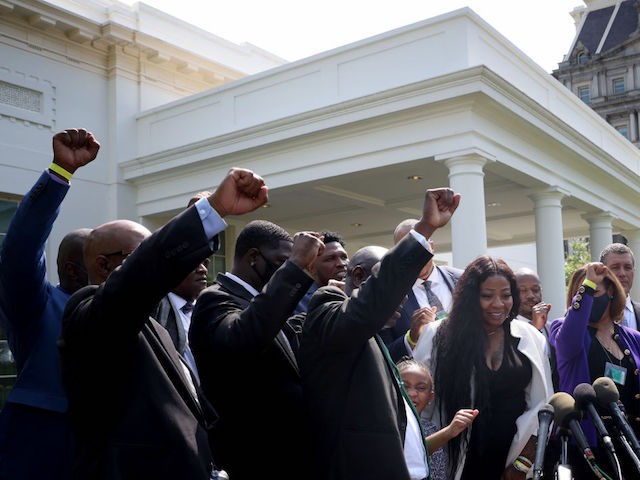WASHINGTON, DC - MAY 25: Members of George Floyd's family raise their fists as they call out "Say his name" after answering questions outside the White House following a meeting with U.S. President Joe Biden May 25, 2021 in Washington, DC. Biden met with Floyd's family members for over an …