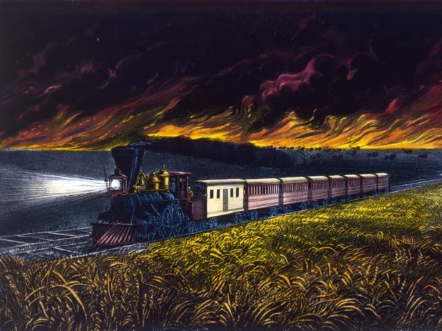 1872: A train speeds across the prairie land of the American West, while behind it a fierce fire rages. Published by Currier & Ives. (Photo by MPI/Getty Images)