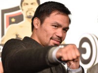 WBO welterweight world champion Manny Pacquiao poses for the media following a press conference at his boxing gym in Tokyo on November 25, 2016. WBO welterweight world champion Manny Pacquiao on November 25 kept alive hopes for a rematch with Floyd Mayweather, saying the epic clash was "possible" but only …
