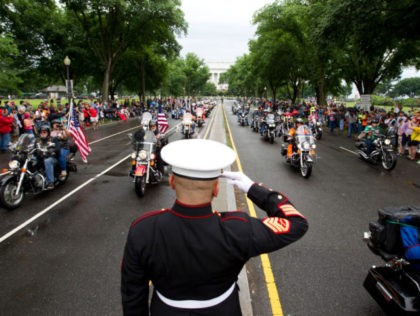 TOPSHOT - US Marine Tim Chambers salutes as participants in the Rolling Thunder annual motorcycle rally ride in Washington DC, on May 28, 2017. Motorcyclists are in Washington for the traditional annual Rolling Thunder ahead of Memorial Day, May 29. / AFP PHOTO / Jose Luis Magana (Photo credit should …