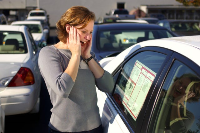 Woman car shopping experiences sticker shock