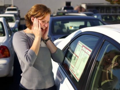 Woman car shopping experiences sticker shock