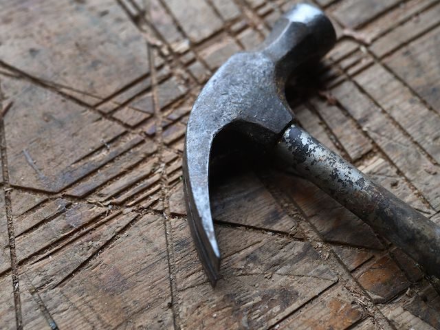 A hammer is pictured on a workbench at the 'Moulin de l'enfer' site in Lannilis, western France on June 10, 2020. - The vocational training site just resumed, after the two-month lockdown, the renovation of 'Bel Espoir', the legendary three masts of father Jaouen. (Photo by Fred TANNEAU / AFP) …