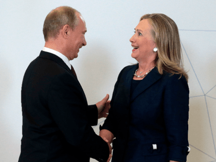 Russian President Vladimir Putin (L) welcomes US Secretary of State Hillary Clinton during