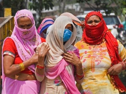 In this picture taken on May 5, 2021, relatives grieve as they arrive for the cremation of their loved one who died due to the Covid-19 coronavirus at a crematorium in Moradabad. - People in India's most populous state Uttar Pradesh are fighting not just a raging pandemic but also …