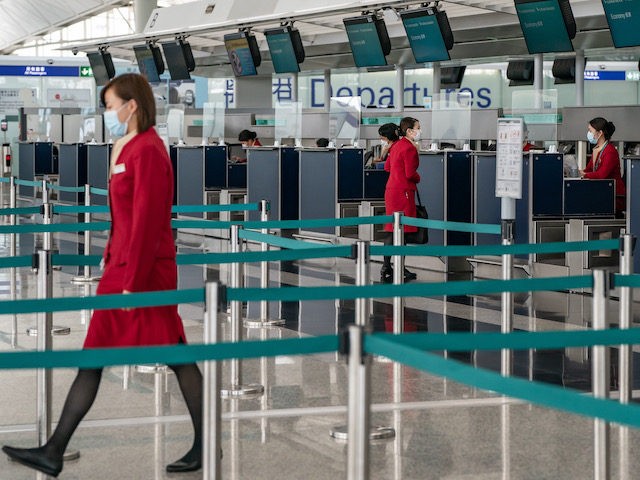 Cathay Pacific ground support workers at check in counter at the Hong Kong International A