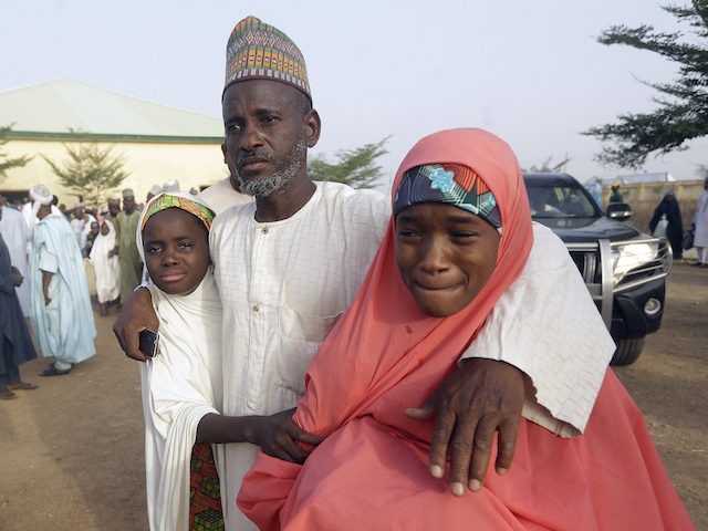 Parents are reunited with their daughter in Jangabe, Nigeria, Wednesday, March 3, 2021. More than 300 schoolgirls kidnapped last week in an attack on their school in northwest Nigeria have arrived in Jangabe after been freed on Tuesday. The Girls were abducted few days ago from Government Girls Secondary School …