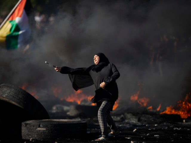 Palestinians clash with Israeli forces at the Hawara checkpoint, south of the West Bank ci