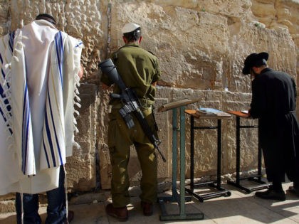 A recently drafted Israeli soldier (C), a modern Orthodox Jew (L) and a traditional ultra-Orthodox Jew (R) pray at the Western Wall, Judaism's holiest site, December 14, 2005 in Jerusalem's Old City. The Jewish state, fragmented along religious, ethnic and political lines, especially after last summer's evacuation from the Gaza …
