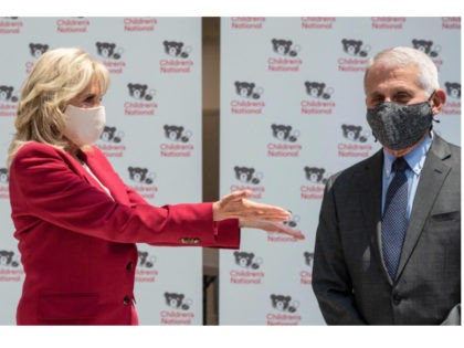 US First Lady Jill Biden and Dr. Anthony Fauci (R) tour the vaccination center at the Chil