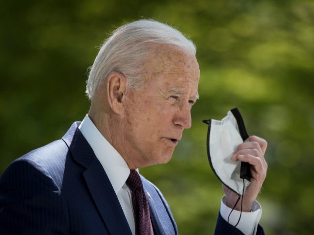 U.S. President Joe Biden removes his mask before speaking about updated CDC mask guidance on the North Lawn of the White House on April 27, 2021 in Washington, DC. President Biden announced updated CDC guidance, saying vaccinated Americans do not need to wear a mask outside when in small groups. …