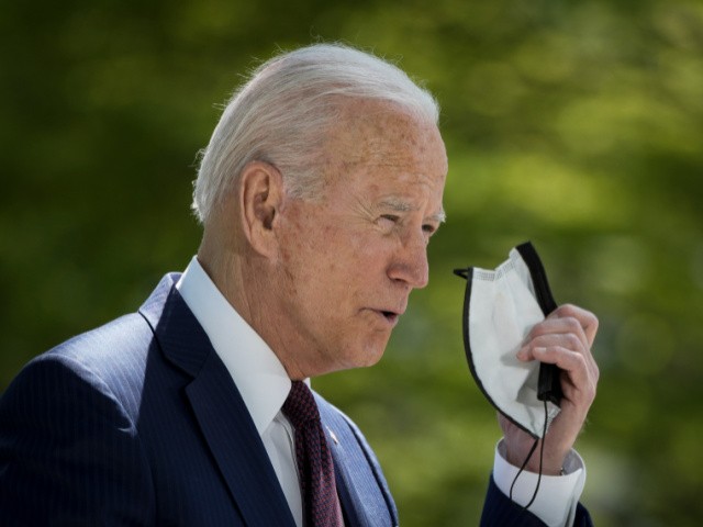 U.S. President Joe Biden removes his mask before speaking about updated CDC mask guidance on the North Lawn of the White House on April 27, 2021 in Washington, DC. President Biden announced updated CDC guidance, saying vaccinated Americans do not need to wear a mask outside when in small groups. (Photo by Drew Angerer/Getty Images)