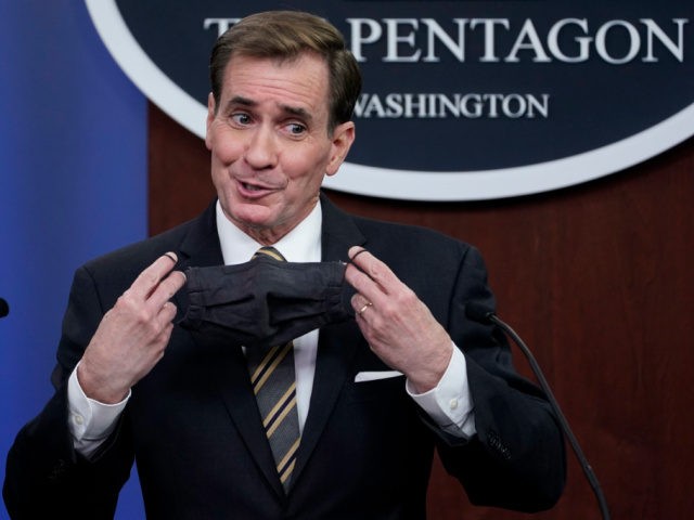 Mandate - Pentagon spokesman John Kirby puts on his face mask at the end of a briefing at