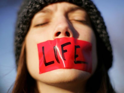 Pro-life activist Lynn Jackson, with the group Bound for Life, protests in front of the U.S. Supreme Court November 30, 2005 in Washington, DC. The highest court in the U.S. is hearing the first case on abortion rights since Chief Justice John Roberts was sworn in.. (Photo by Win McNamee/Getty …