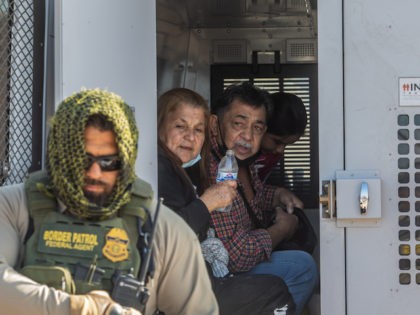 YUMA, AZ - May 13, 2021: A familiy of asylum seekers from Colombia are seeing inside a Border Patrol Inmate transport after they turns herselves to the US Border Patrol Agents on May 12, 2021 in Yuma, Arizona. Migrants Continue To Cross Southern Border As Biden Administration Grapples With Surge. …