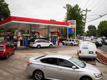 Motorists line up at an Exxon station selling gas at $3.29 per gallon soon after it's fuel supply was replenished in Charlotte, North Carolina on May 12, 2021. - Fears the shutdown of the Colonial Pipeline because of a cyberattack would cause a gasoline shortage led to some panic buying …