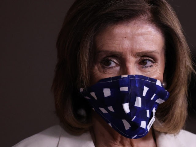 Speaker of the House Nancy Pelosi (D-CA) wears a cloth mask to cover her mouth and nose to prevent the spread of the novel coronavirus during her weekly news conference at the U.S. Capitol April 30, 2020 in Washington, DC. While she and Democratic House leaders are not going to …