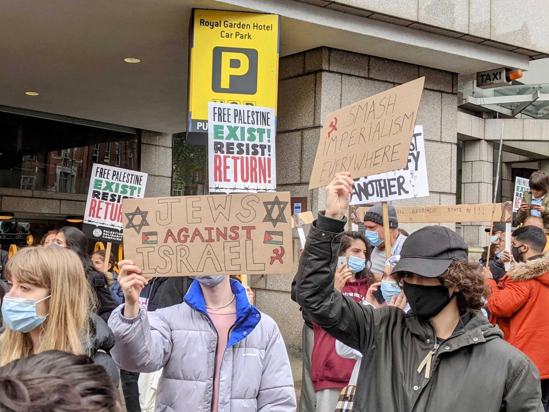 Protesters are seen carrying placards reading "Jews Against Israel" and "Smash Impearialism Everywhere, at an anti-Israel protest in London. May 15th, 2021. Kurt Zindulka, Breitbart News