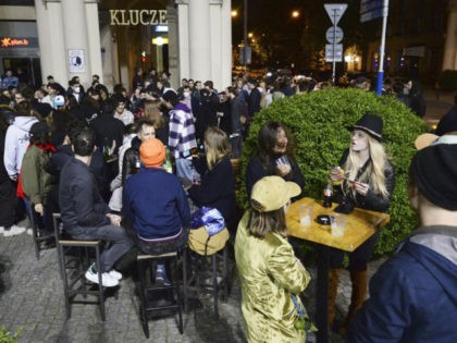 People gather and celebrate as bars, clubs and other establishments reopened in Poland after being closed for seven months, in Warsaw, Poland, Friday, May 14, 2021. (AP Photo/Czarek Sokolowski)
