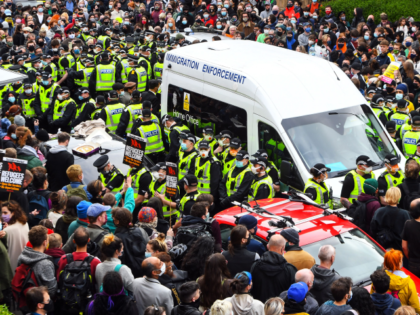 Protesters surround an Immigration Enforcement van to stop it from departing after individuals were detained in Glasgow on May 13, 2021. (Photo by Andy Buchanan / AFP) (Photo by ANDY BUCHANAN/AFP via Getty Images)