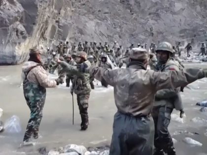 This video frame grab taken from footage recorded in mid-June 2020 and released by China Central Television (CCTV) on February 20, 2021 shows Chinese (foreground) and Indian soldiers (R, background) during an incident where troops from both countries clashed in the Line of Actual Control (LAC) in the Galwan Valley, …