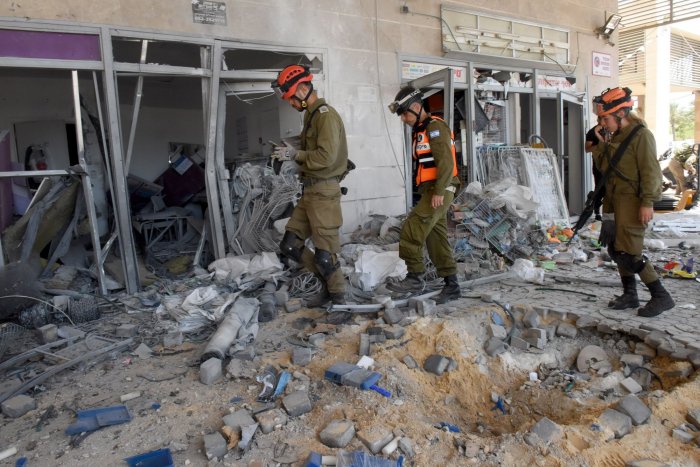 Israeli soldiers look at the damage of a building hit by a rocket fired from the Gaza Strip. Photo by Debbie Hill/UPI 