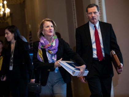 WASHINGTON, DC - JANUARY 21: (L-R) Sen. Shelley Moore Capito (R-WV) and Sen. John Barrasso (R-WY) walk to a Republican Senate caucus meeting at the U.S. Capitol on January 21, 2020 in Washington, DC. The Senate impeachment trial of U.S. President Donald Trump resumes on Tuesday. (Photo by Drew Angerer/Getty …