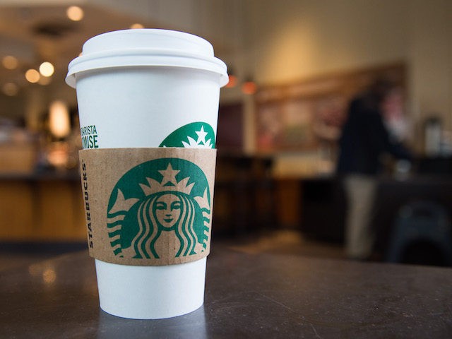 A Starbucks coffee cup is seen inside a Starbucks Coffee shop in Washington, DC, April 17, 2018, following the company's announcement that they will close more than 8,000 US stores on May 29 to conduct "racial-bias education" following the arrest of two black men in one of its cafes. (SAUL …