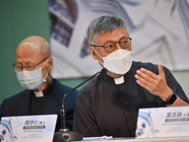Newly appointed Bishop of Hong Kong Rev. Stephen Chow (R) speaks at a press conference wit