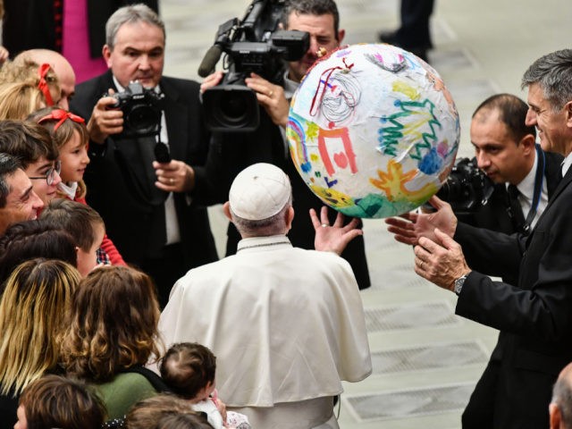 Pope Francis (C) and his butler, Sandro Mariotti (R) bounce a ball covered in children&#03