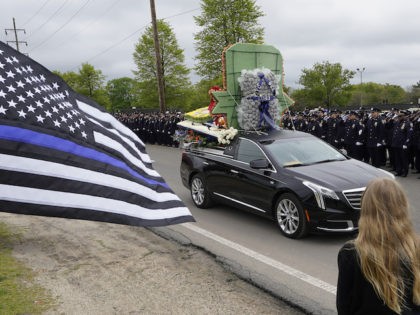 Thousands of police officers line the street as the funeral procession of New York police officer Anastasios Tsakos leaves the St. Paraskevi Greek Orthodox Shrine Church, Tuesday, May 4, 2021, in Greenlawn, N.Y. Tsakos was at the scene of an accident on the Long Island Expressway when he was struck …