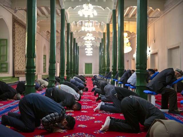 Uyghurs and other members of the faithful pray at the Id Kah Mosque in Kashgar in western China's Xinjiang Uyghur Autonomous Region, as seen during a government organized trip for foreign journalists, Monday, April 19, 2021. A human rights group is appealing to the United Nations to investigate allegations China's government is committing crimes against humanity in the Xinjiang region. Human Rights Watch cited reports of the mass detention of Muslims, a crackdown on religious practices and other measures against minorities in the northwestern region. (AP Photo/Mark Schiefelbein)