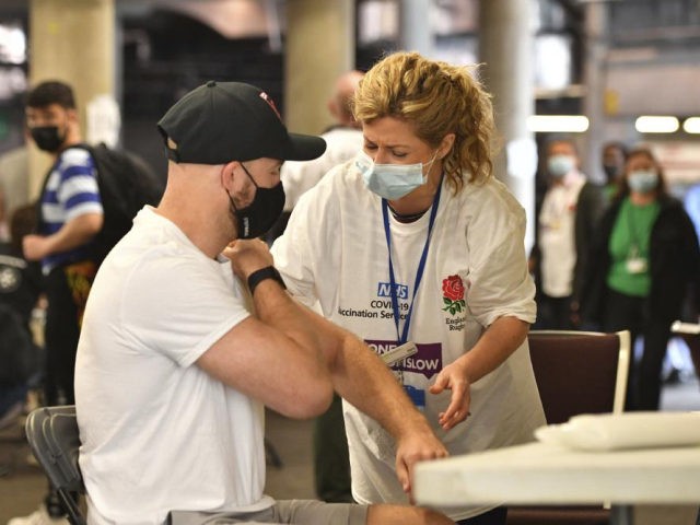 A member of the public prepares to receive a coronavirus vaccination at a surge vaccine op