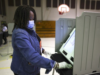 Poll manager Sheila Tyson sanitizes a voting booth on Election Day on November 3, 2020 in Orangeburg, South Carolina. After a record-breaking early voting turnout, Americans head to the polls on the last day to cast their vote for incumbent U.S. President Donald Trump or Democratic nominee Joe Biden in …