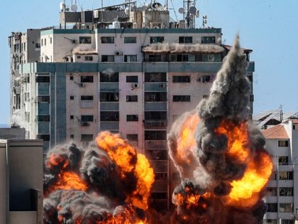 TOPSHOT - A ball of fire erupts from the Jala Tower as it is destroyed in an Israeli airstrike in Gaza City, controlled by the Palestinian Hamas movement, on May 15, 2021. - Israeli air strikes pounded the Gaza Strip, killing 10 members of an extended family and demolishing a …