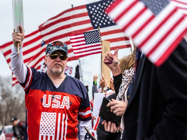 Trump supporters display US flags and signs as the Minnesota chapter of the Council on American-Islamic Relations (CAIR-MN) and a coalition of community organizations in support of Minnesota Representative Ilhan Omar gathered outside the Nuss Truck and Equipment in Burnsville, Minnesota where US President Donald Trump spoke on April 15, …