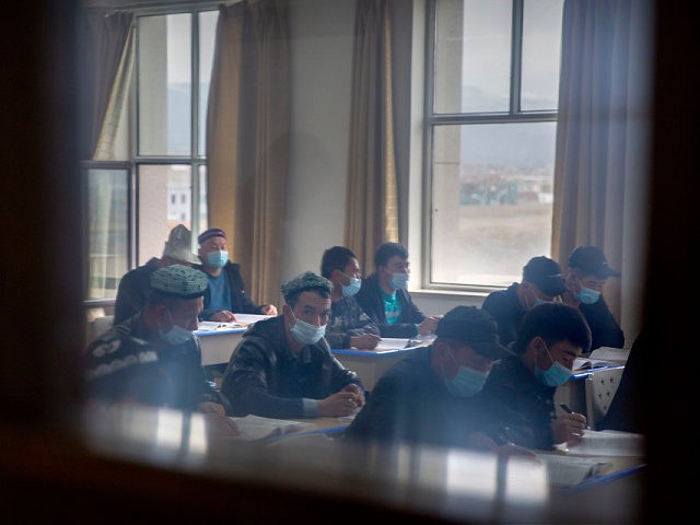 Uyghurs and other students attend a class at the Xinjiang Islamic Institute, as seen durin