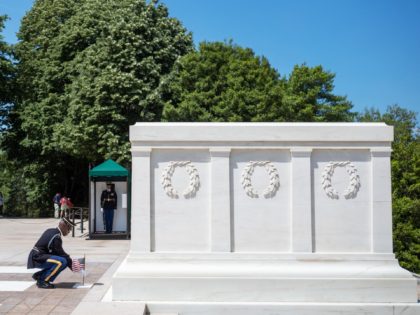 A soldier from the 3rd US Infantry Regiment, the "Old Guard", places a US flag at the Tomb of the Unknown Soldier in Arlington National Cemetery in Arlington, Virginia on May 27, 2021. - The "Flags In" tradition takes place ahead of Memorial Day which honors service members who died …
