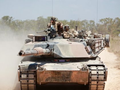 MOUNT BUNDEY TRAINING AREA, Northern Territory, Australia – Marines with Alpha Company, 1st Tank Battalion, engage a target from an M1A1 Abrams Main Battle Tank during Exercise Gold Eagle 2013, here, Sept. 14. The exercise is an annual, reciprocal, company-level military exchange between the Australian Army and the Marine Corps. …