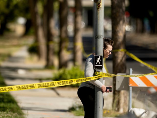 A woman leaves the scene of a shooting at a Santa Clara Valley Transportation Authority (V