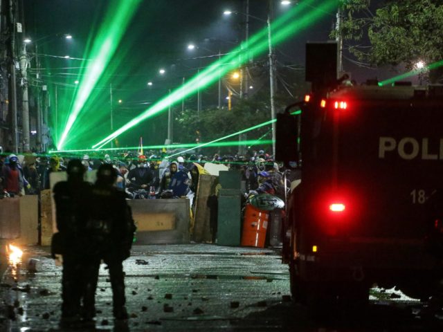 Anti-government protesters point lasers at police during clashes in Bogota, Colombia, Frid