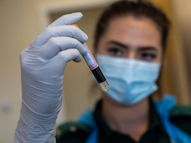 BIRMINGHAM, ENGLAND - JUNE 05: Jess Baddams, paramedic, holds a blood sample as she poses