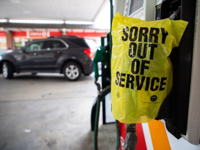 An "Out Of Service" bag covers a gas pump as cars continue line up for the chance to fill their gas tanks at a Circle K near uptown Charlotte, North Carolina on May 11, 2021 following a ransomware attack that shut down the Colonial Pipeline. - Fears the shutdown of …